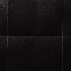 Fototapeta premium A textured black surface with subtle grid lines creating a pattern.