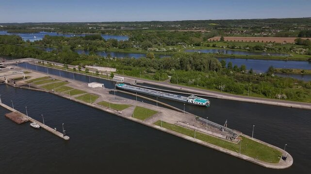Barge enters lock on river Maas at Ecluse de Lanaye near Belgium and Netherlands border