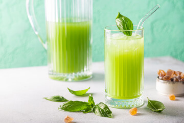 Fototapeta premium Cold basil lemonade refreshing summer drink on gray background