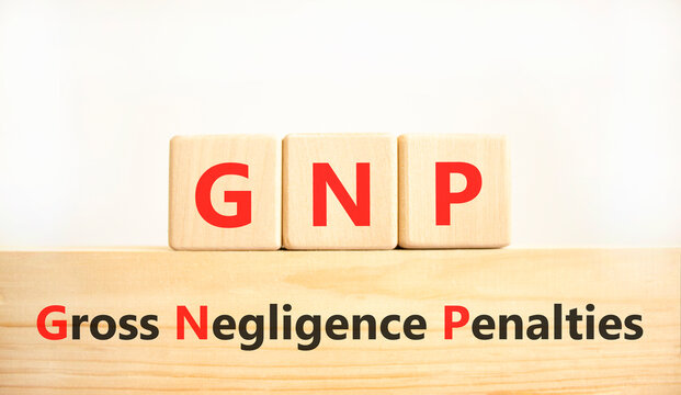 GNP gross negligence penalties symbol. Concept words GNP gross negligence penalties on beautiful wooden blocks. Beautiful white background. Business GNP gross negligence penalties concept. Copy space