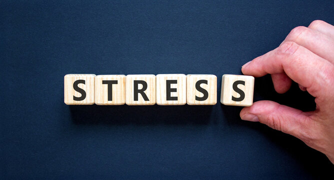 Stress word symbol. Concept word Stress on beautiful wooden blocks. Beautiful black background. Psychologist's hand. Business psychological medical stress word concept. Copy space.