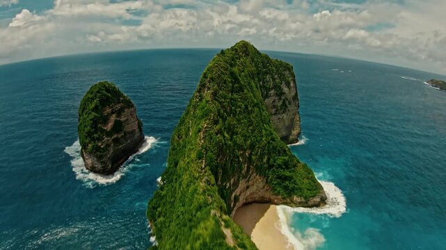 FPV drone flight above Kelingking Beach ridge and tropical coastline in Nusa Penida Bali Indonesia