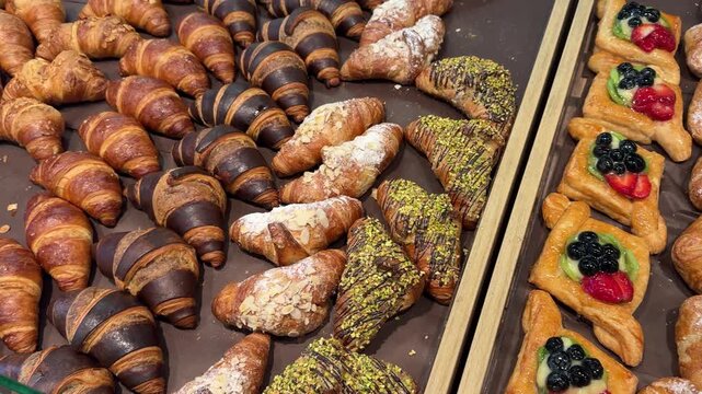 Bakery display sliding shot over assorted fresh pastries