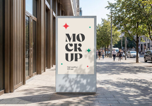 Front view of a vertical city light billboard mockup standing on a sunny pedestrian sidewalk street with shadows and people walking in the background