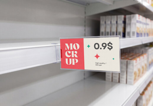 Close-up perspective view of a supermarket shelf price tag mockup in a clear plastic holder on an empty white store shelf with blurred products in the background
