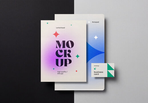 Top view of a minimalist corporate stationery branding mockup featuring a letterhead paper, a notepad, and a business card on a split black and grey background