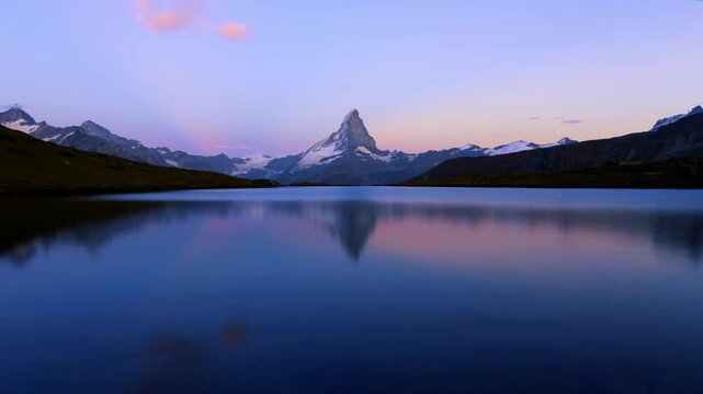Matterhorn reflected in calm alpine lake at dusk near Zermatt, Switzerland