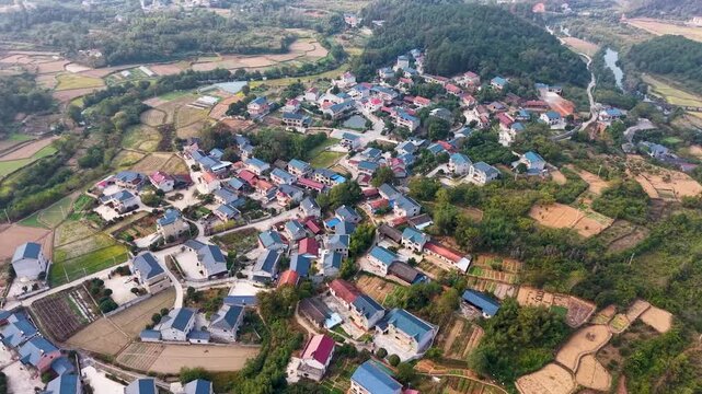 Aerial View of Rural Village with Farmland and Forested Hills