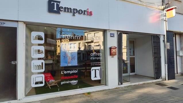 Saintes, France - April 21, 2026: Saintes. Temporis employment agency storefront with large glass windows displaying job offers and recruitment services in a city setting