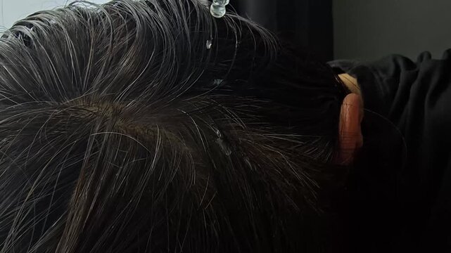 Hair treatment in a salon during afternoon with hair applied by a stylist for smoother texture