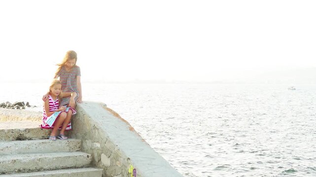 Two little beautiful girls walk in Nesebar, Bulgaria