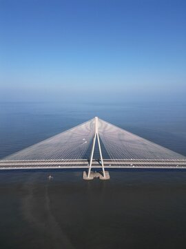 Aerial view of the Bandra-Worli Sea Link bridge with its A-shaped pylon and cables over the Arabian Sea in Mumbai, Maharashtra, India.