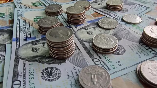Gathering of coins and bills on a table at a home setting during daytime