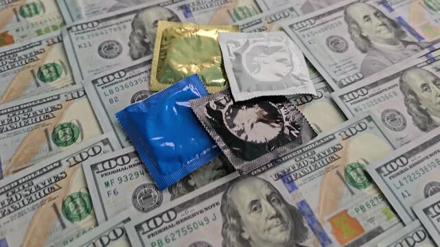 Discussion on safe practices in intimate settings using condoms on a backdrop of cash