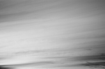 Obraz premium Gray background, gray sky and clouds in the photo in the form of various lines and stripes with gradient transitions