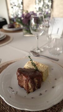 Pork Bondiola with Potato Millefeuille in a gala table setting
