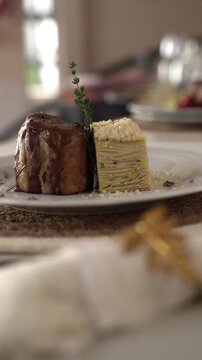 Pork Bondiola with Potato Millefeuille in a gala table setting