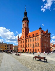 Obraz premium Historic Red Brick Town Hall Standing in Sunny European Market Square