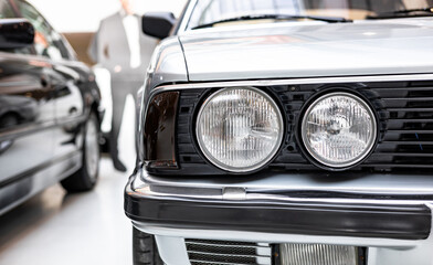 Close-up of a headlight of a classic car. Front of a car. Retro car © NastyaPhoto