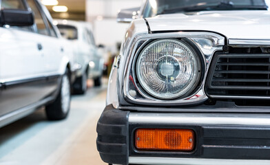 Close-up of a headlight of a classic car. Front of a car. Retro car © NastyaPhoto