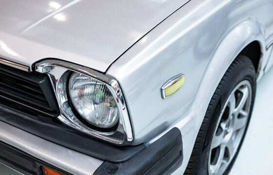 Close-up of a headlight of a classic car. Front of a car. Retro car