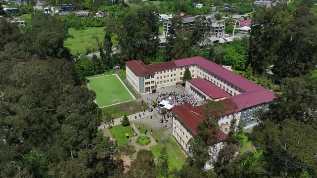 Chakvi, Georgia &mdash; May 22 2026: Aerial drone view of Public School N1 building complex surrounded by lush green trees and coastal landscape in Adjara region.