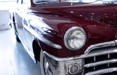 Fototapeta premium Classic American cars street display, old vintage vehicle show. Headlight of a classic American car