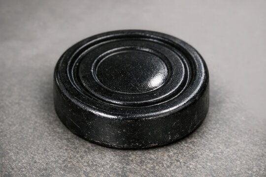 A close-up view of a mysterious black object sitting on a table