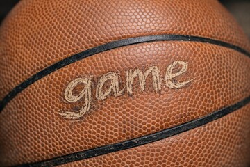 Fototapeta premium A basketball with the words 'game' written on it, for sports and fitness related concepts