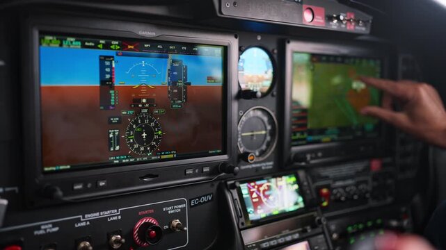 Pilot operating touch screen gps navigation system in cockpit