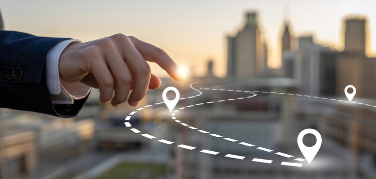 Businessman hand pointing to a winding dotted path with location pins representing a strategic business route.