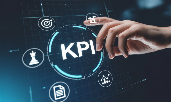 Business hand interacting with virtual screen showing KPI key performance indicators strategy and business icons on dark background.