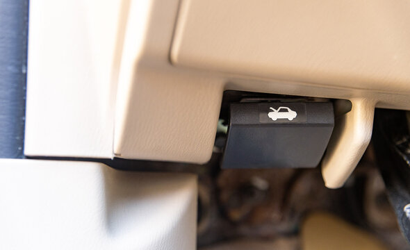 Car bonnet release lever, car interior. Hand pulling car bonnet release - button for open car hood