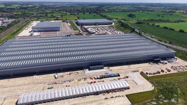 Aerial View of Large Distribution Center and Logistics Warehouse With Trucks and Loading Bays