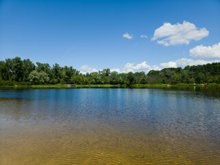 Obraz premium Sandy Beach River Summer Blue Sky Nature Calm Water Shore Green Trees Landscape