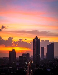 Fototapeta premium Vibrant City Skyline Silhouetted at Sunset in Urban Downtown