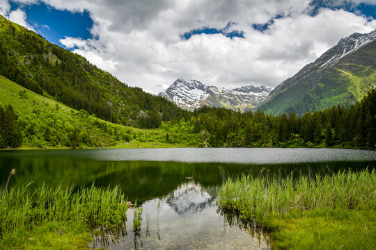 Snowy peak reflected in a calm mountain lake