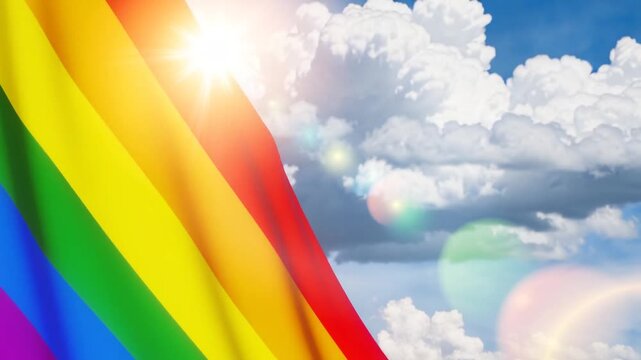 Waving LGBT pride flag on the blue sky, rainbow flag background. Multicolored peace flag movement. Original colors symbol.