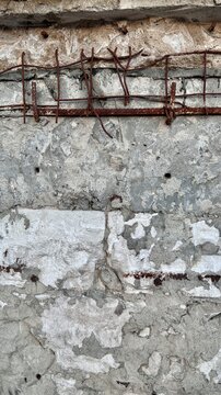 rusty rebar grid embedded in cracked concrete wall with copy space