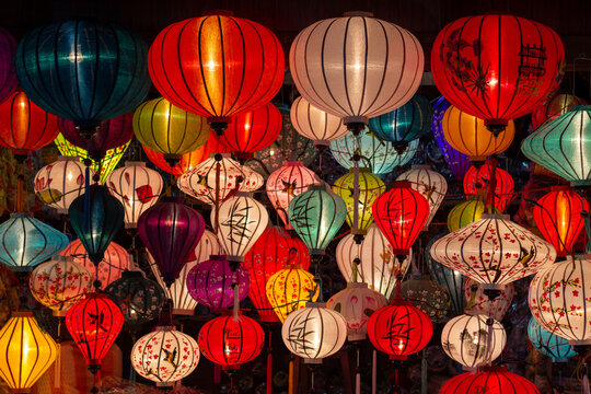 Traditional colourful Vietnamese silk lanterns illuminating a night market stall in Hoi An ancient town