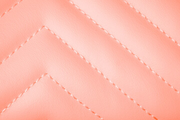 Naklejka premium Soft pastel peach luxurious quilted leather background with elegant precise zigzag stitching pattern
