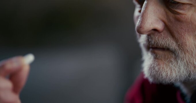 Thoughtful older bearded man in profile with soft natural light