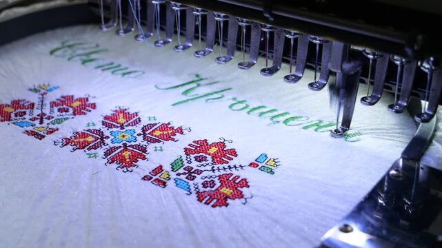 Machine embroidery of the inscription Holy Baptism with colored threads on a white terry cloth. Baptism cloth with cross stitch for Bulgarian tradition. 4k video.