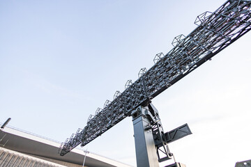 Military equipment and army equipment.. Powerful heavy lift crane stands among port and dock infrastructure. Impressive massive crane towers over maritime dock areas with complex rigging © NastyaPhoto