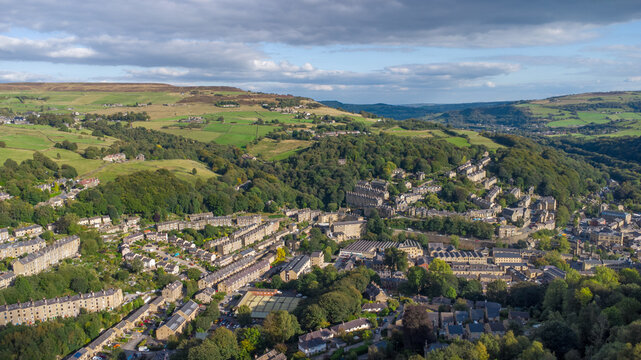 High aerial view of the town of Hebden Bridge in West Yorkshire showing the streets surrounded by autumn countryside