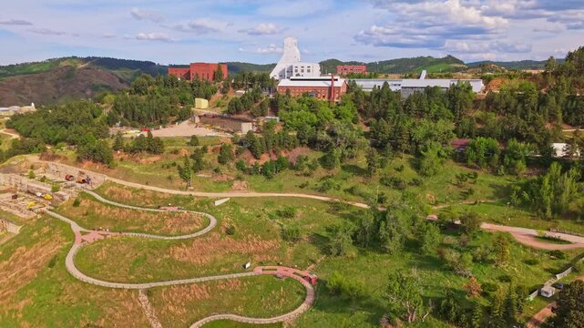 Scenic aerial view of Lead South Dakota surrounded by forested hills on a summer day