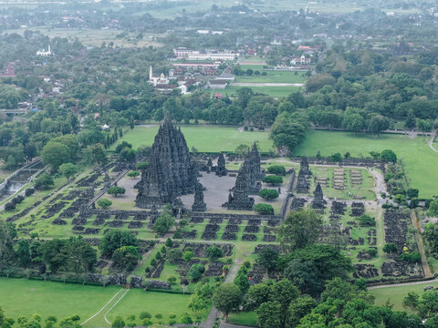 Aerial view of the Prambanan Temple complex featuring ancient stone spires and lush green gardens in Kecamatan Prambanan, Daerah Istimewa Yogya, Indonesia.