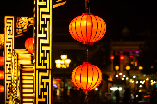 Traditional orange silk lanterns hanging at night in the historic old town of Hoi An Vietnam