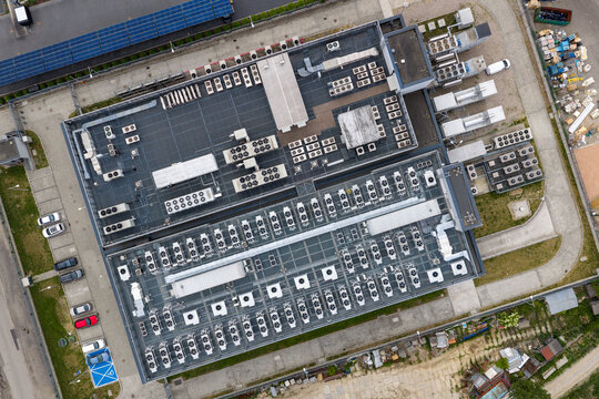 Aerial view of the AI datacenter building with HVAC units and ventilation systems on the roof in Warszawa, Wojewodztwo mazowieckie, Poland.