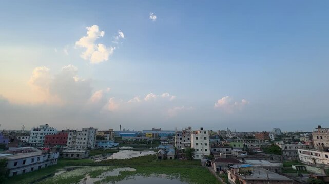 Dramatic Golden Hour Sun Rays Breaking Through Clouds Over Cityscape and Wetlands